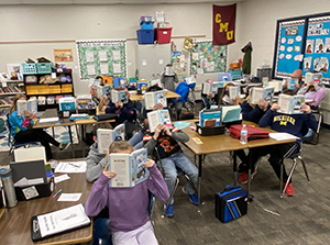 Kids in a school classroom reading books