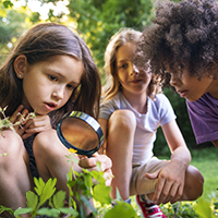 Citizen Scientist - Kids exploring nature with a magnifying glass.