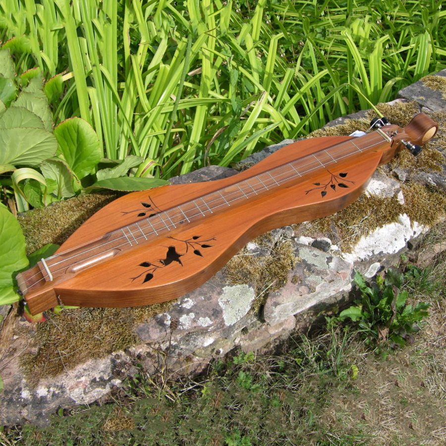 Mountain dulcimer on display on a flat rock