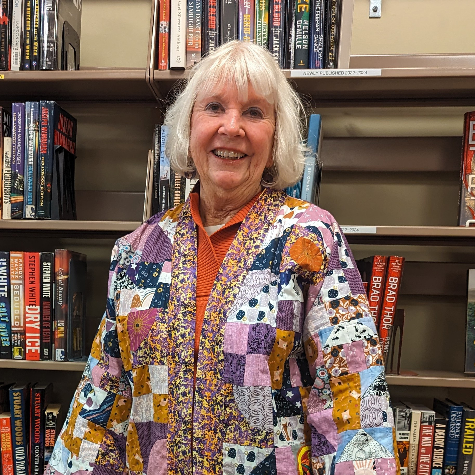 Linda Kuhlman in front of bookshelf