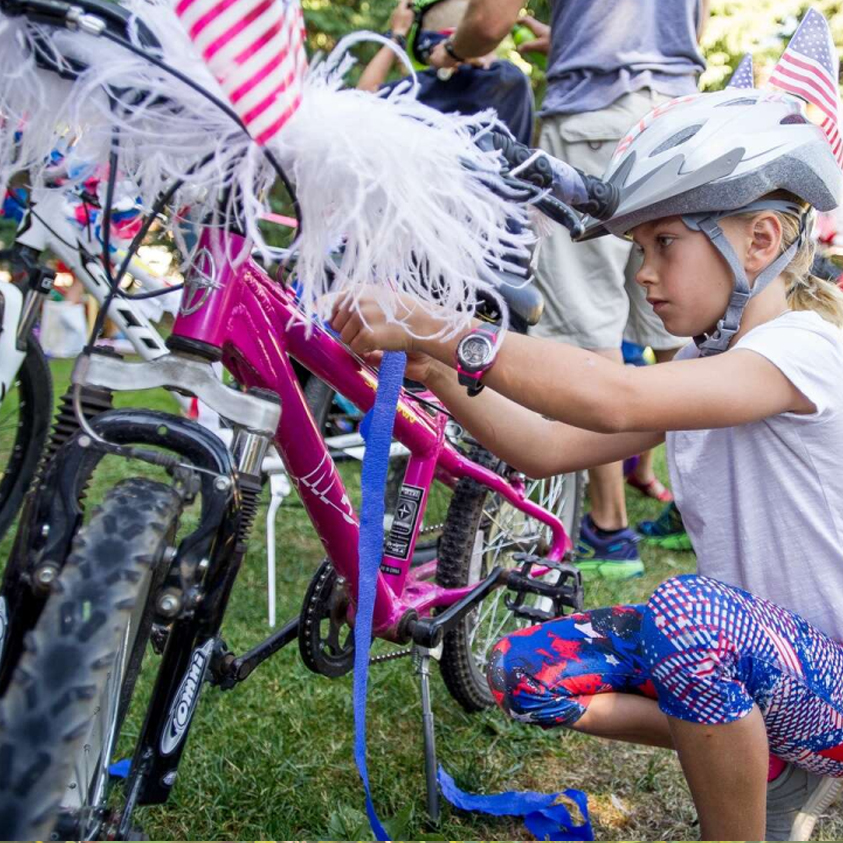 Girl decorating her bike with patriotic items