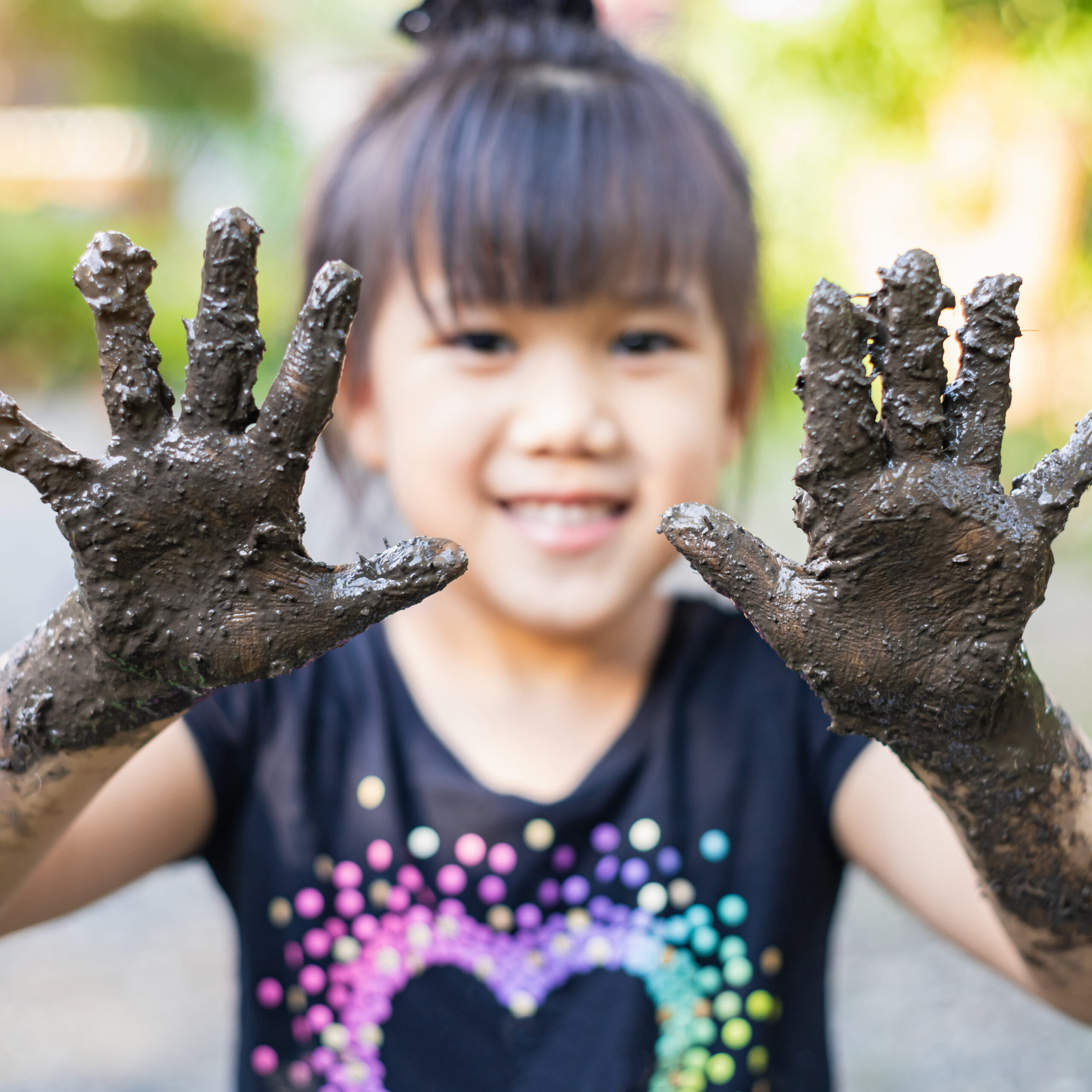 Smiling kid with muddy hands