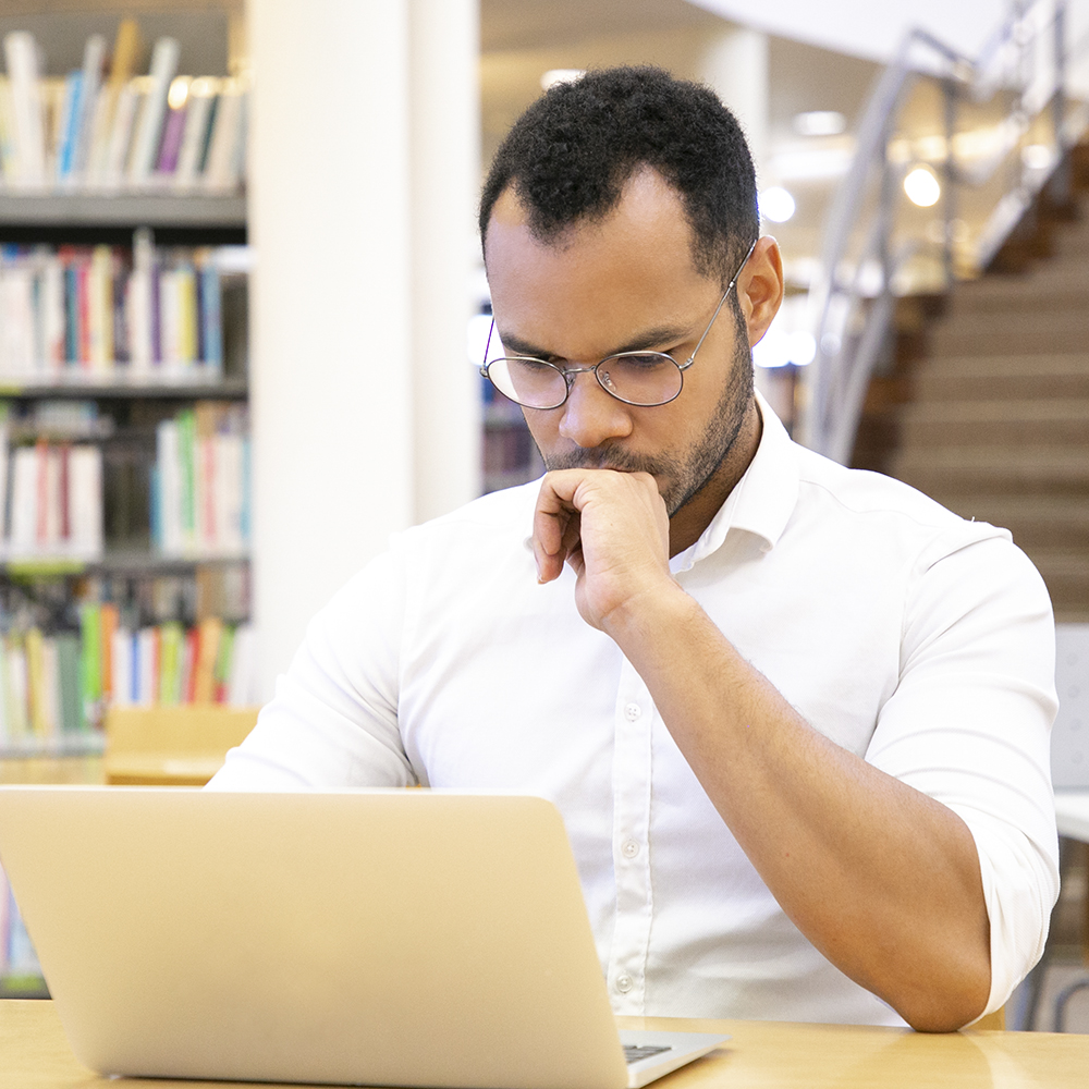 Man at computer deep in thought