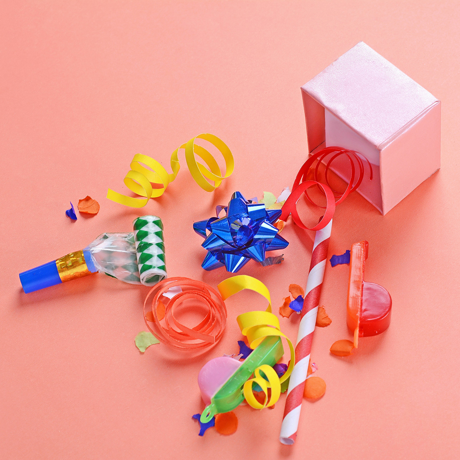 Box spilling out party decorations and noisemakers