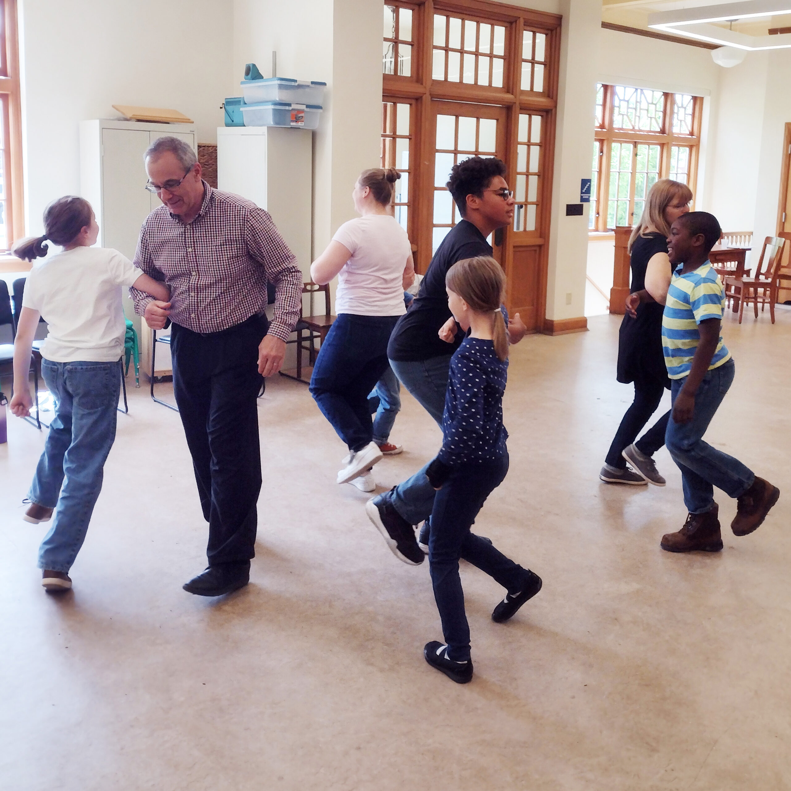 People of all ages learning how to square dance