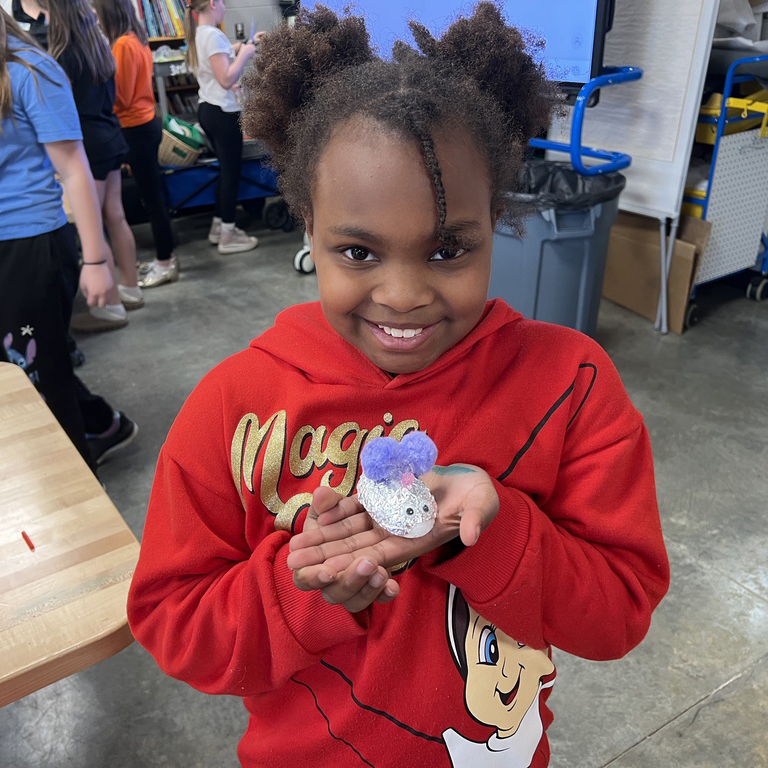Kid with red sweater holding a Jitter Critter creation