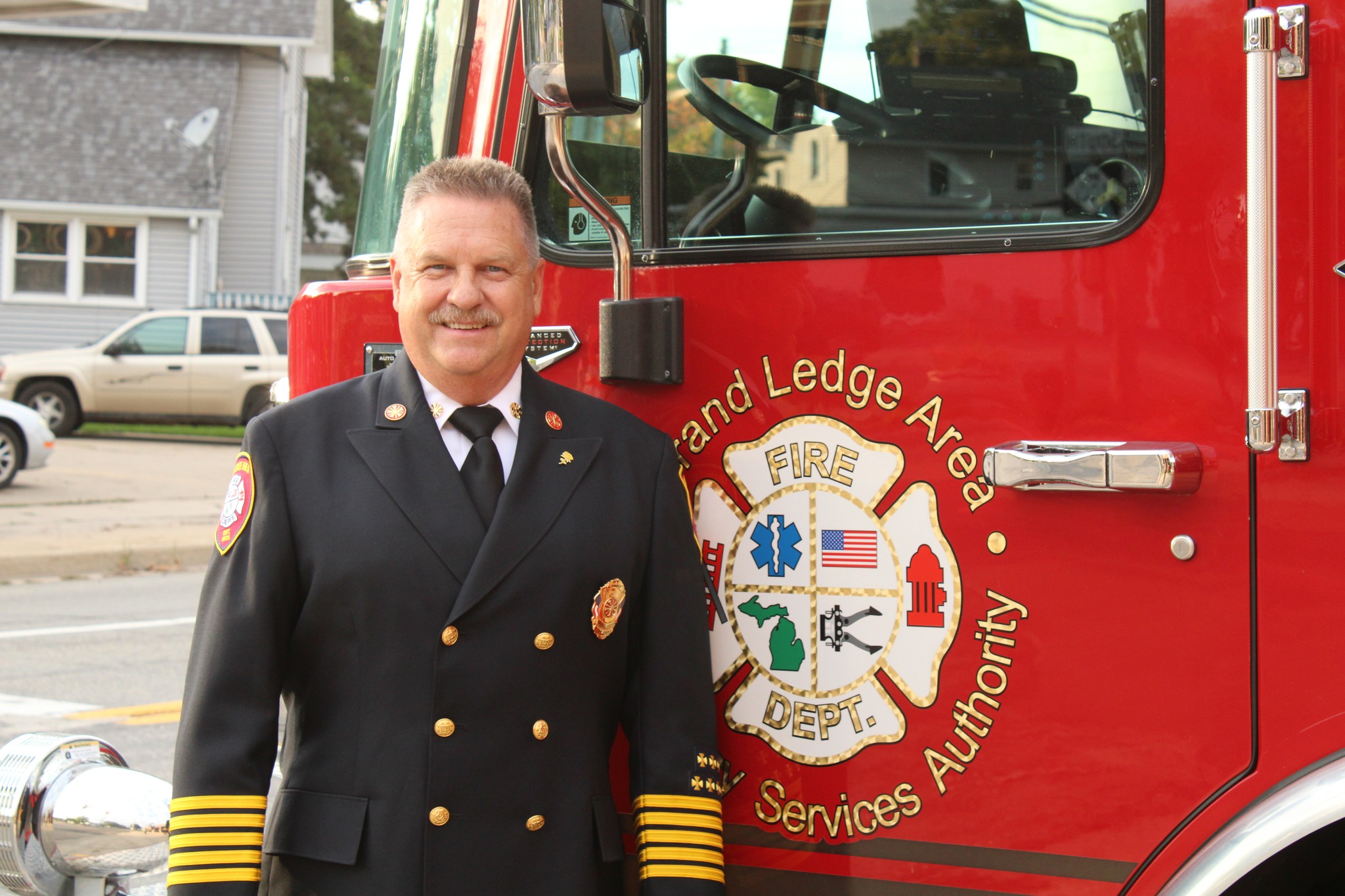 Fire Chief Mike Roman beside a Fire Truck
