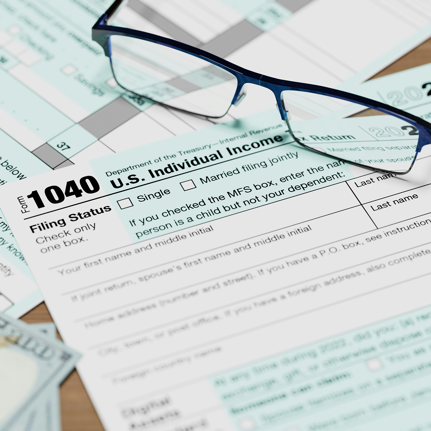 Tax forms with glasses on top of papers