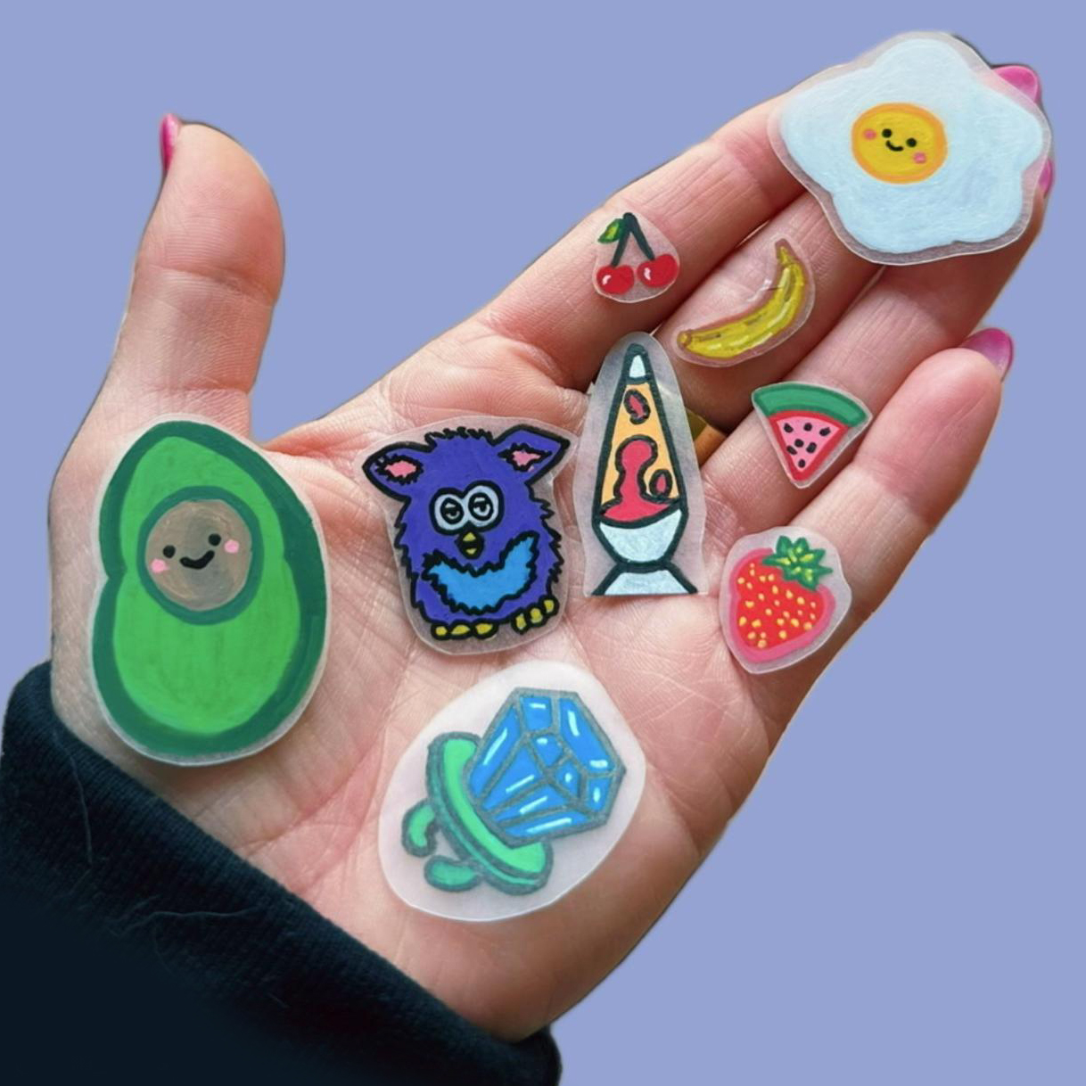 Hand holding shrinky dinks