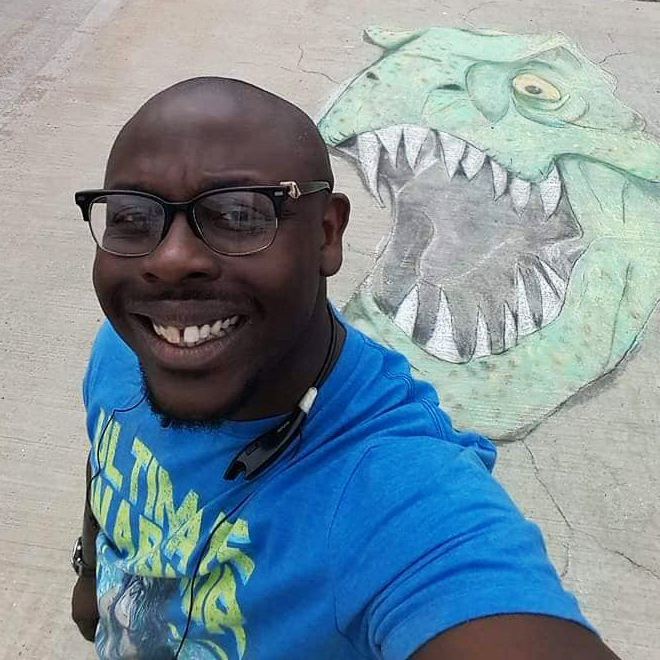 Ryan Holmes with dinosaur chalk art