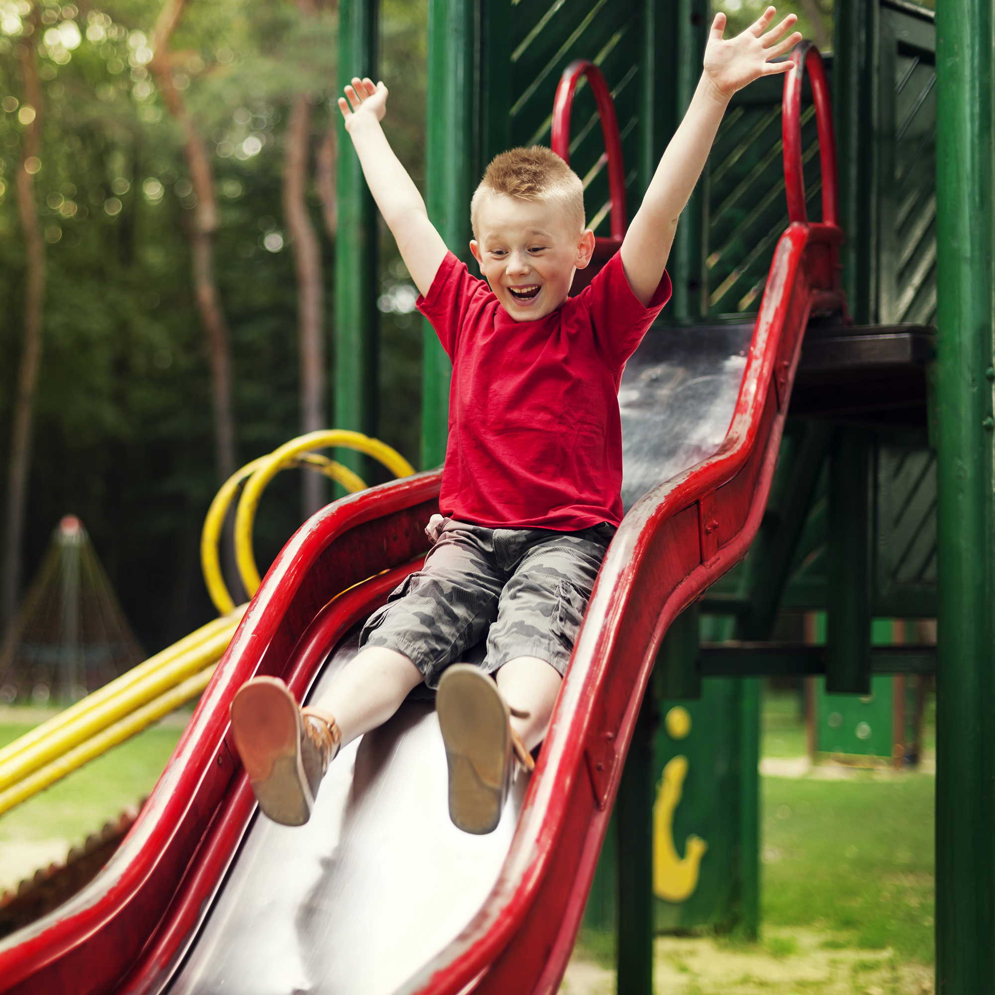 Boy going down slide