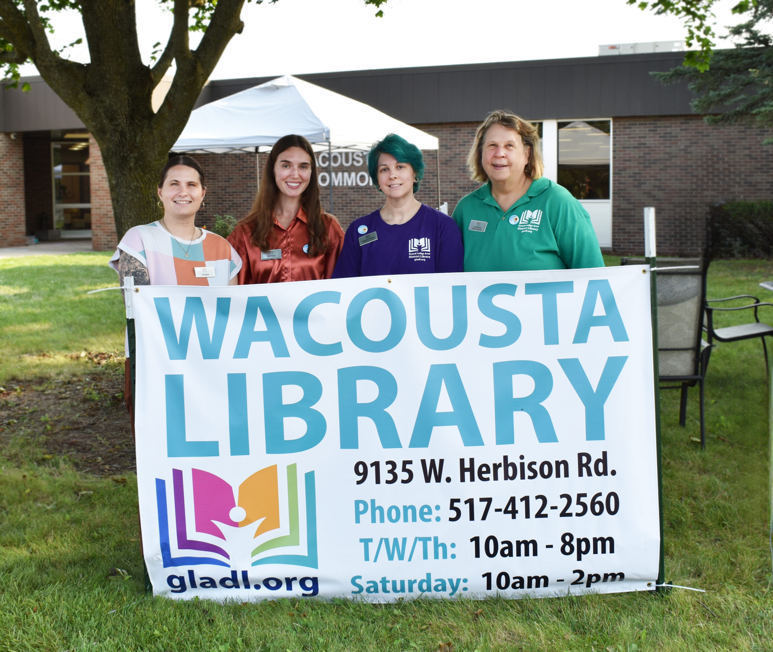 Wacousta ribbon cutting, staff behind branch sign
