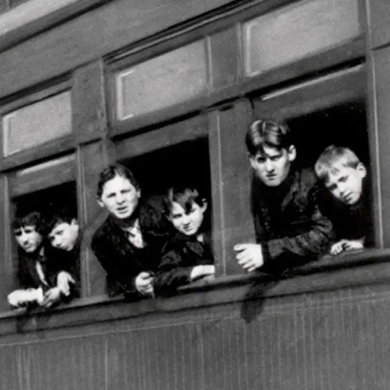 Old photo of kids hanging out of a train window